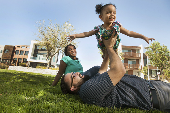 Parents playing with their young child