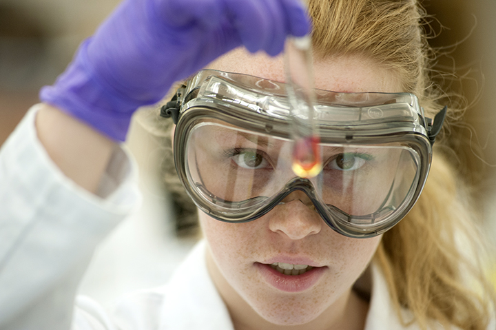 Close-up of a student examining a test tube in a science lab