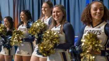 The UC Davis cheer team greets guests