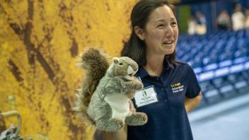 A staff member from the Arboretum holds a squirrel puppet
