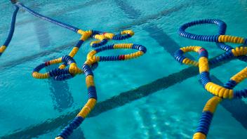 lap pool with blue and gold lane lines drifing