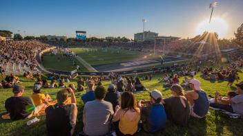 outdoor football stadium, packed with fans watching a UC Davis football game