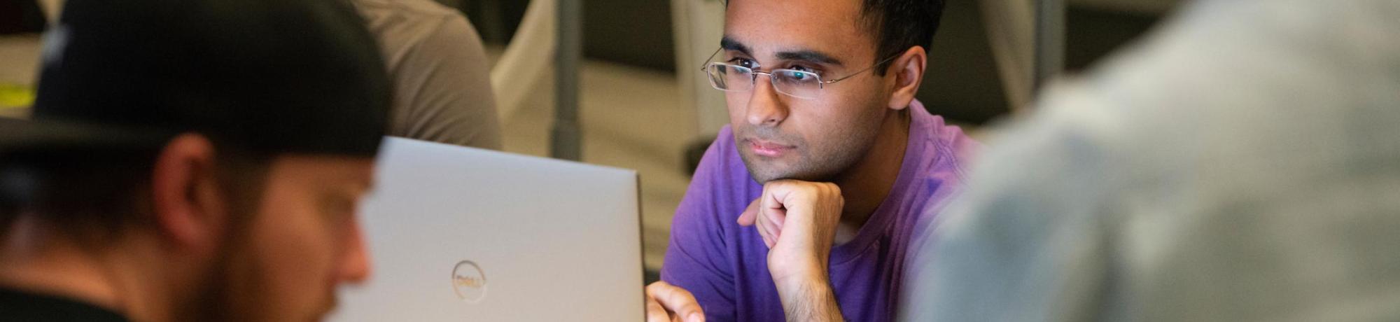 man reviews data on his laptop