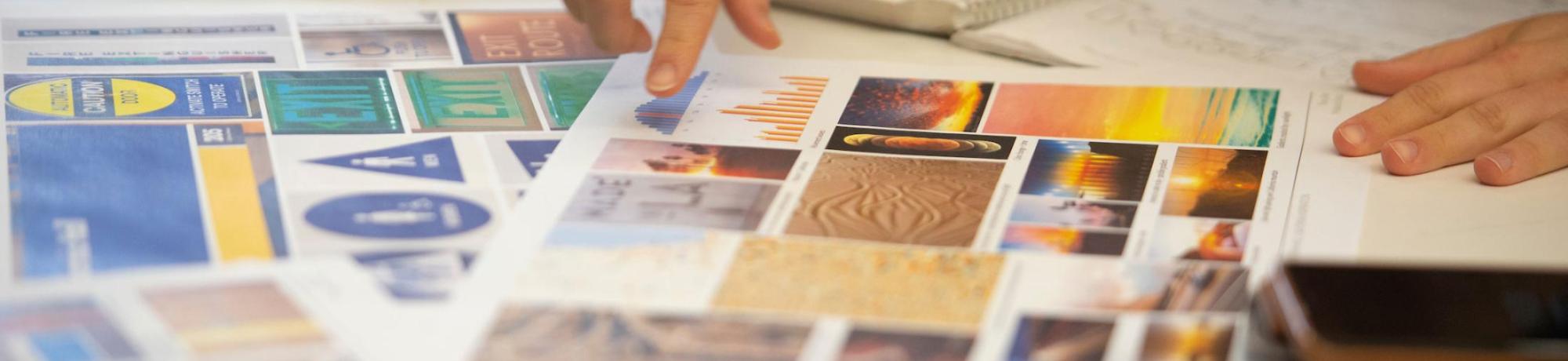 A student points to elements on her style guide as part of a design class