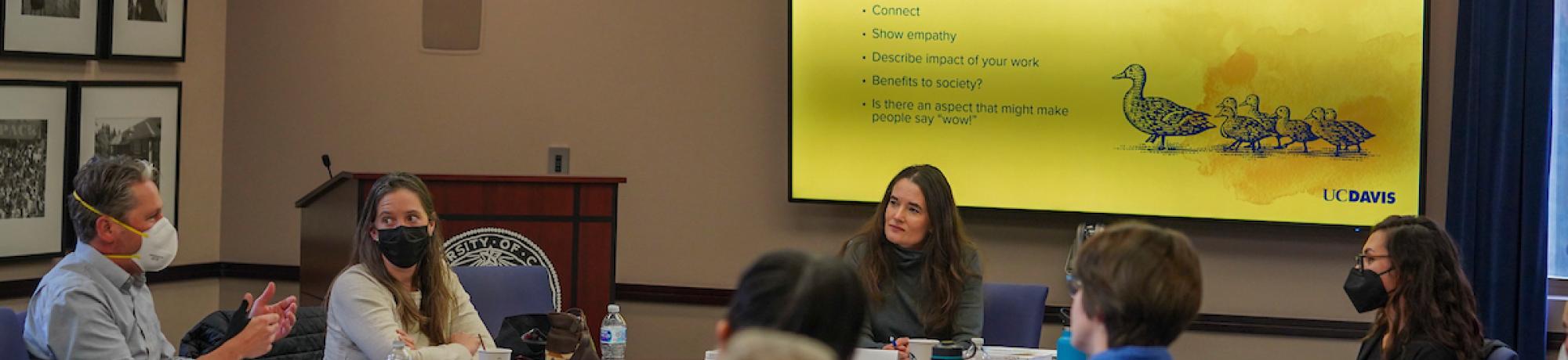 people in a discussion at a Communicators training event at UC Davis